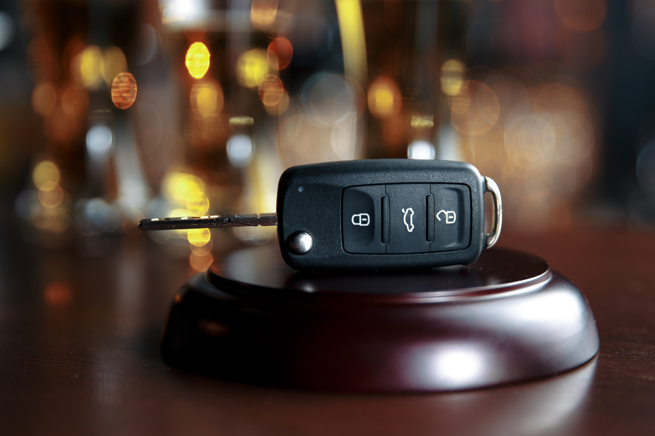 Car key on top of a judges gavel in a bar