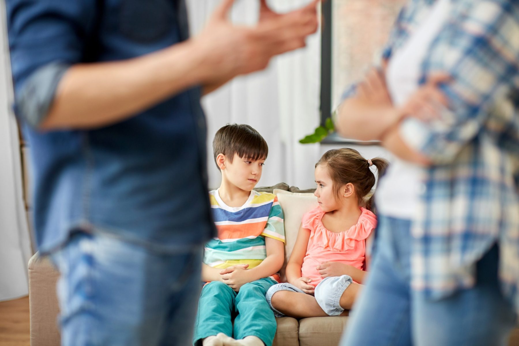 Sad children watching their parents fight at home.