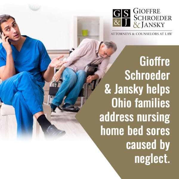 Nurse speaking on the phone while an elderly man struggles in a wheelchair in the background, illustrating potential nursing home neglect.