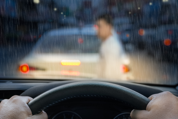 View from inside a car of person crossing the street.