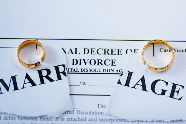 Ripped paper with words marrige and wedding rings.