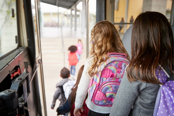 Group of students getting off the school bus.