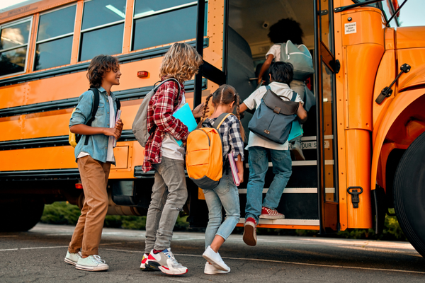 Students walking inside bus.